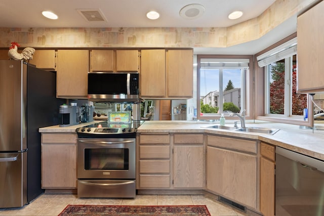 3001 S Winthrop Ln, Spokane, WA 99203 - kitchen featuring appliances with stainless steel finishes, light tile patterned flooring, light countertops, and light brown cabinetry
