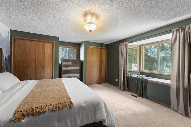 3114 W 20th Ave, Spokane, WA 99224 - bedroom with multiple closets, light colored carpet, and a textured ceiling