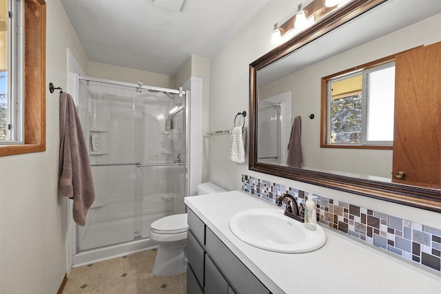 3114 W 20th Ave, Spokane, WA 99224 - bathroom featuring decorative backsplash, vanity, and a stall shower