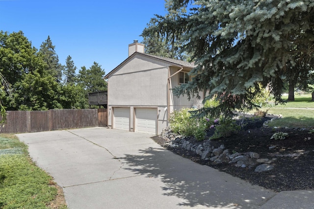 3114 W 20th Ave, Spokane, WA 99224 - view of side of home with a chimney, driveway, and a garage
