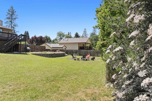 3114 W 20th Ave, Spokane, WA 99224 - fenced backyard with stairway, a wooden deck, and an outdoor fire pit