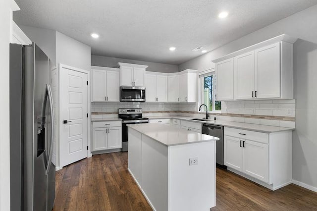 12413 E Dickens Ln, Spokane Valley, WA 99206 - kitchen with stainless steel appliances, decorative backsplash, dark wood finished floors, light countertops, and recessed lighting