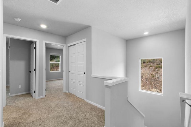 12413 E Dickens Ln, Spokane Valley, WA 99206 - hallway with an upstairs landing, carpet floors, a textured ceiling, and recessed lighting