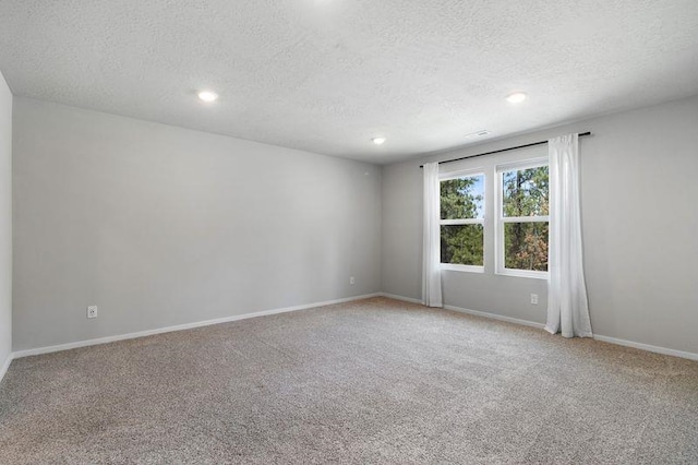 12413 E Dickens Ln, Spokane Valley, WA 99206 - spare room with a textured ceiling, light carpet, and recessed lighting