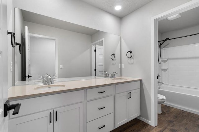 12413 E Dickens Ln, Spokane Valley, WA 99206 - full bath with double vanity, wood finished floors, shower / bathtub combination, and a textured ceiling