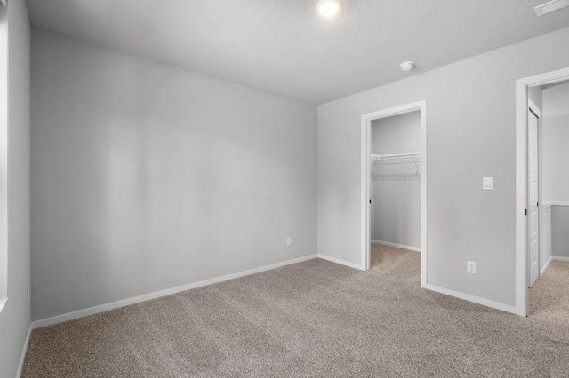 12413 E Dickens Ln, Spokane Valley, WA 99206 - unfurnished bedroom featuring carpet floors, a spacious closet, and a closet