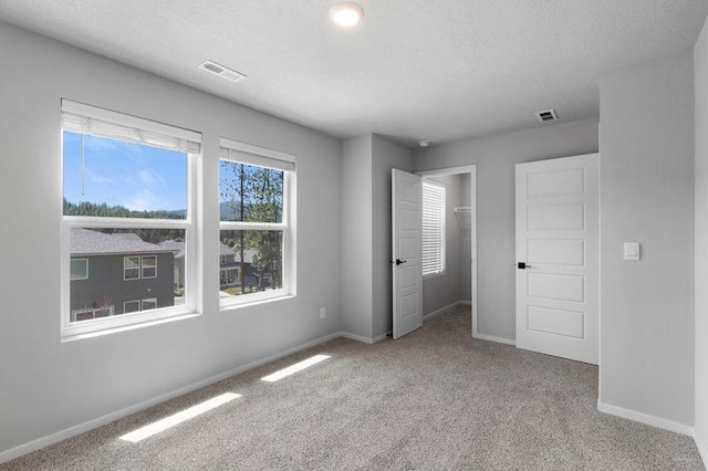 12413 E Dickens Ln, Spokane Valley, WA 99206 - unfurnished bedroom featuring carpet, a closet, and a spacious closet