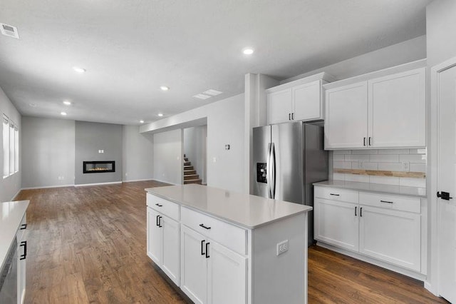 12413 E Dickens Ln, Spokane Valley, WA 99206 - kitchen featuring stainless steel refrigerator with ice dispenser, recessed lighting, decorative backsplash, dark wood-style flooring, and a kitchen island