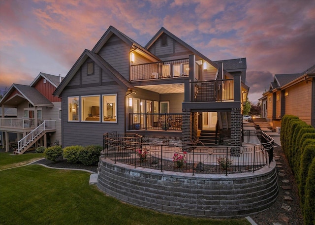2605 S Cherrytree Ln, Spokane, WA 99203 - back of property at dusk with a balcony, stairway, a yard, and a patio area