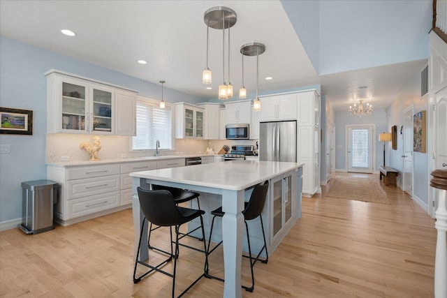2605 S Cherrytree Ln, Spokane, WA 99203 - kitchen with appliances with stainless steel finishes, a chandelier, plenty of natural light, a kitchen bar, and recessed lighting