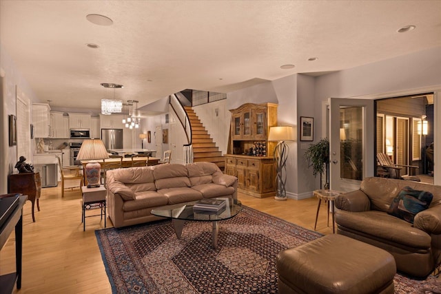 2605 S Cherrytree Ln, Spokane, WA 99203 - living room featuring stairway, a chandelier, and light wood-style flooring