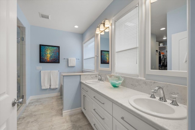 2605 S Cherrytree Ln, Spokane, WA 99203 - bathroom featuring double vanity, a tile shower, and wood finished floors