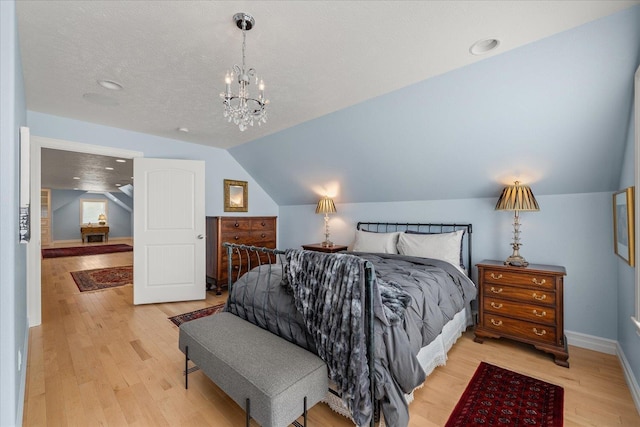 2605 S Cherrytree Ln, Spokane, WA 99203 - bedroom with light wood-style flooring, lofted ceiling, and a chandelier