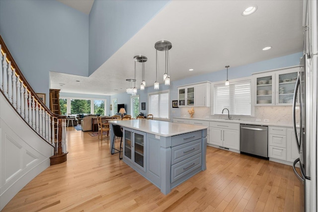 2605 S Cherrytree Ln, Spokane, WA 99203 - kitchen with appliances with stainless steel finishes, white cabinetry, open floor plan, light countertops, and recessed lighting