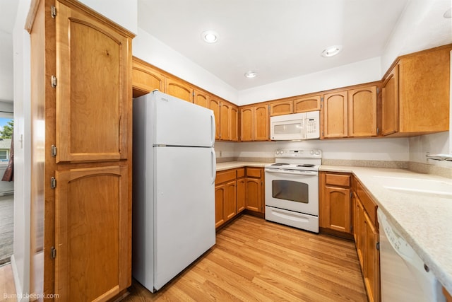 10914 E 7th Ave, Spokane Valley, WA 99206 - kitchen featuring white appliances, light countertops, light wood-style floors, brown cabinetry, and recessed lighting