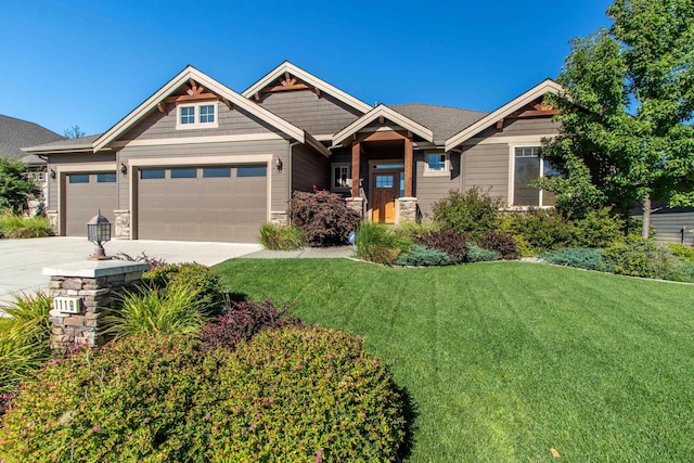 1119 N River Ridge Blvd, Spokane, WA 99224 - craftsman-style house with a garage, stone siding, a front lawn, and concrete driveway