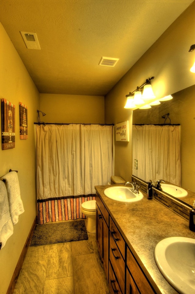1119 N River Ridge Blvd, Spokane, WA 99224 - bathroom featuring double vanity, a textured ceiling, and shower / tub combo with curtain