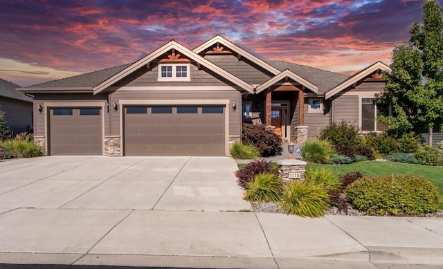 1119 N River Ridge Blvd, Spokane, WA 99224 - craftsman-style house with concrete driveway, an attached garage, and stone siding