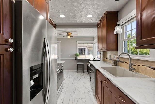 5130 N Stevens St, Spokane, WA 99205 - kitchen with appliances with stainless steel finishes, light marble finish flooring, hanging light fixtures, tasteful backsplash, and a ceiling fan