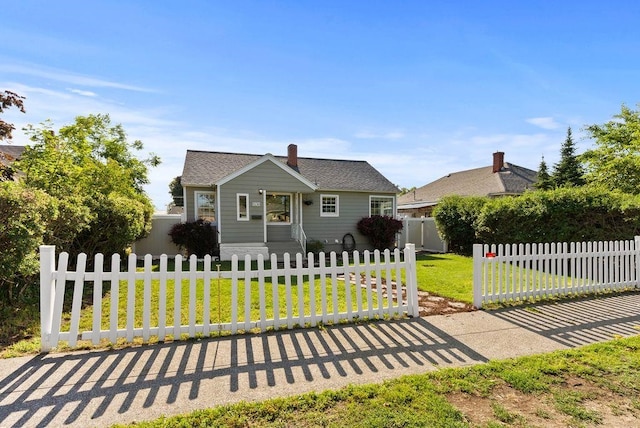 5130 N Stevens St, Spokane, WA 99205 - bungalow with a fenced front yard, a chimney, and roof with shingles