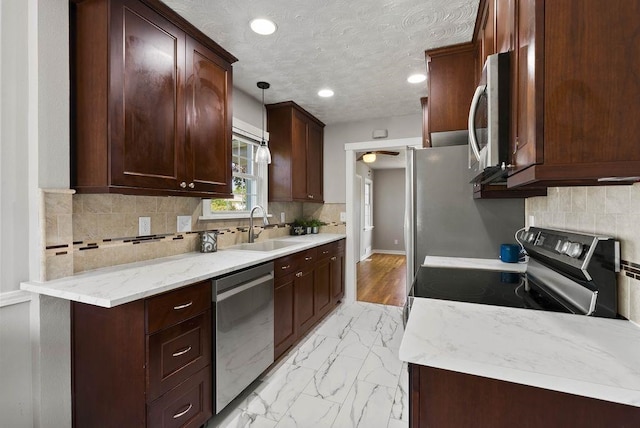 5130 N Stevens St, Spokane, WA 99205 - kitchen featuring appliances with stainless steel finishes, backsplash, light marble finish floors, pendant lighting, and recessed lighting