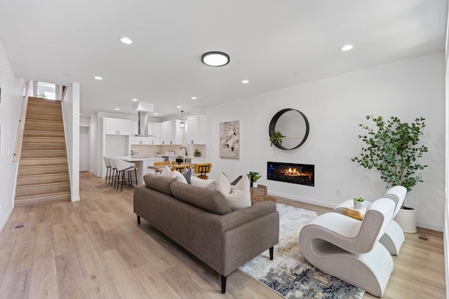 2009 W 9th Ave, Spokane, WA 99204 - living area with stairway, light wood-style floors, recessed lighting, and a glass covered fireplace
