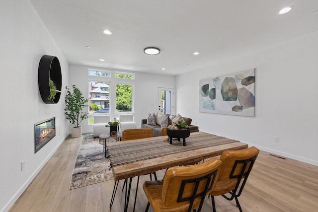 2009 W 9th Ave, Spokane, WA 99204 - dining space featuring a glass covered fireplace, light wood-style floors, and recessed lighting