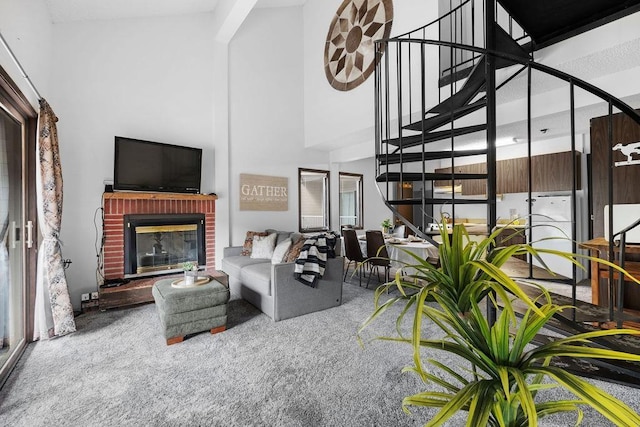 28600 N Mt Spokane Park Dr # 632, Mead, WA 99021 - carpeted living area with stairway, a high ceiling, and a fireplace