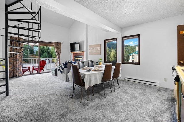 28600 N Mt Spokane Park Dr # 632, Mead, WA 99021 - dining space featuring a baseboard heating unit, carpet floors, a textured ceiling, a fireplace, and high vaulted ceiling