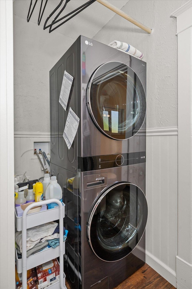337 E 20th Ave, Spokane, WA 99203 - laundry room featuring stacked washer / dryer, wainscoting, and wood finished floors