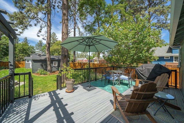 337 E 20th Ave, Spokane, WA 99203 - wooden deck with outdoor dining space, a fenced backyard, an outdoor structure, and a grill