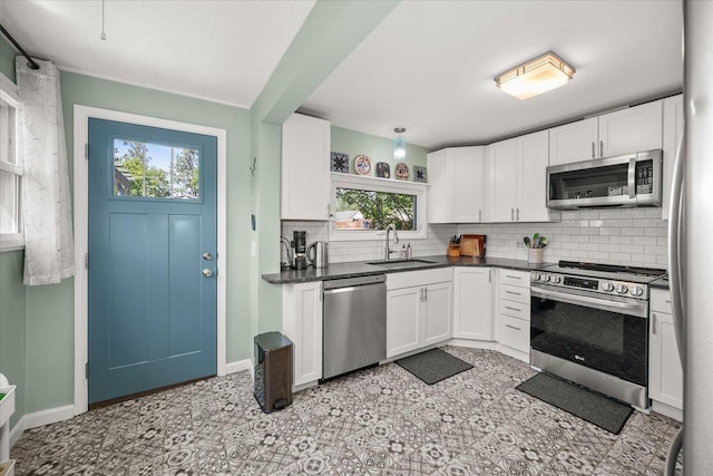337 E 20th Ave, Spokane, WA 99203 - kitchen with stainless steel appliances, healthy amount of natural light, decorative backsplash, and dark countertops
