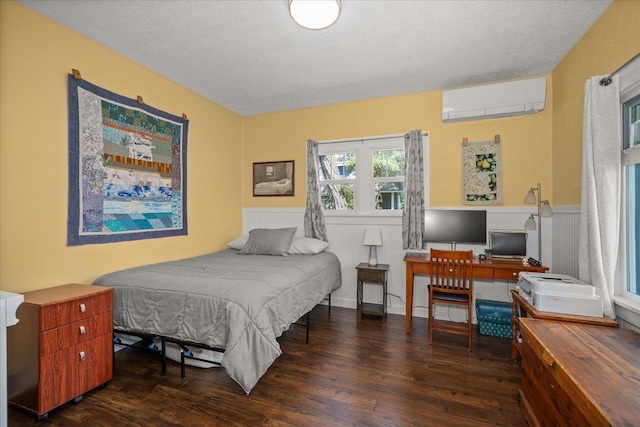 337 E 20th Ave, Spokane, WA 99203 - bedroom with a wall unit AC, wood finished floors, a textured ceiling, and a wainscoted wall