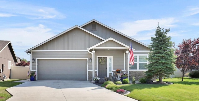 2809 W Ashley Cir, Spokane, WA 99208 - craftsman-style house with a front lawn, driveway, an attached garage, board and batten siding, and stone siding