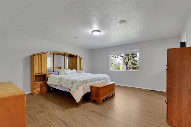 5818 S Abbott Rd, Spokane, WA 99224 - bedroom with light wood finished floors and a textured ceiling