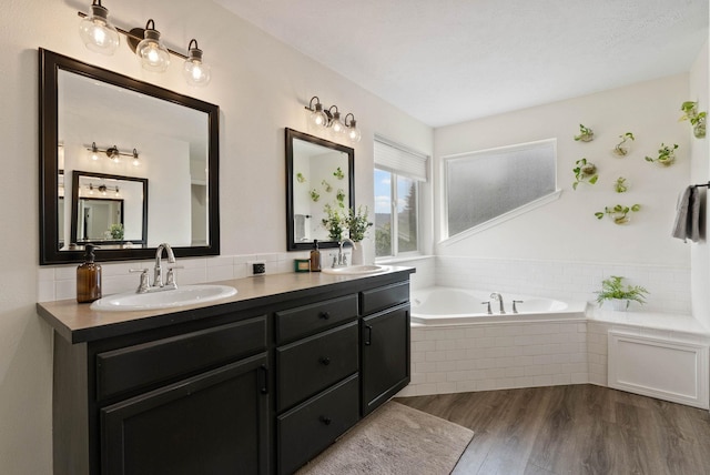 3205 S Mcdonald St, Spokane Valley, WA 99206 - bathroom with double vanity, a garden tub, and wood finished floors