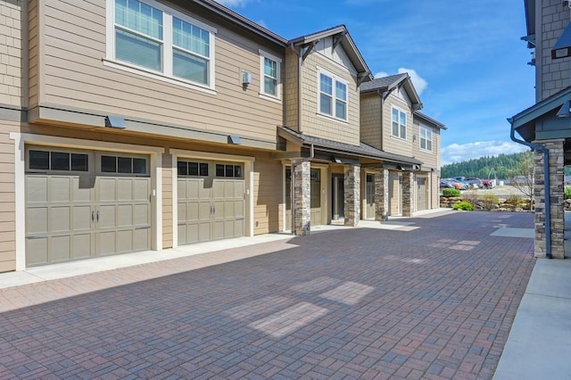 24493 E Pinnacle Ct # D, Liberty Lake, WA 99019 - view of front of property featuring a garage, driveway, and stone siding