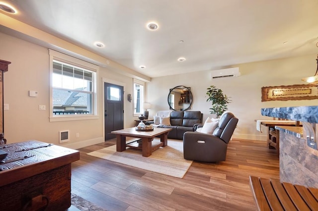 24493 E Pinnacle Ct # D, Liberty Lake, WA 99019 - living room featuring a wall unit AC, light wood finished floors, and recessed lighting