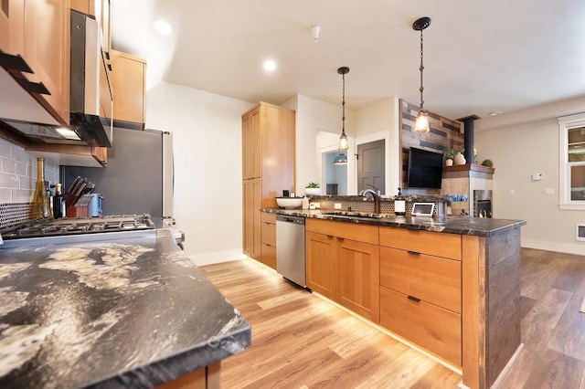 24493 E Pinnacle Ct # D, Liberty Lake, WA 99019 - kitchen with dishwasher, a peninsula, tasteful backsplash, light wood-type flooring, and decorative light fixtures