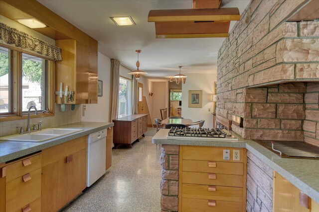3303 W 8th Ave, Spokane, WA 99224 - kitchen with white dishwasher, backsplash, stainless steel gas stovetop, decorative light fixtures, and a peninsula