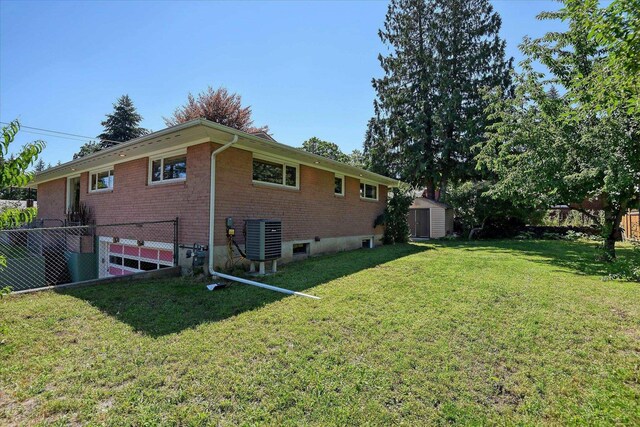 3303 W 8th Ave, Spokane, WA 99224 - back of property with brick siding, a storage unit, and an attached garage