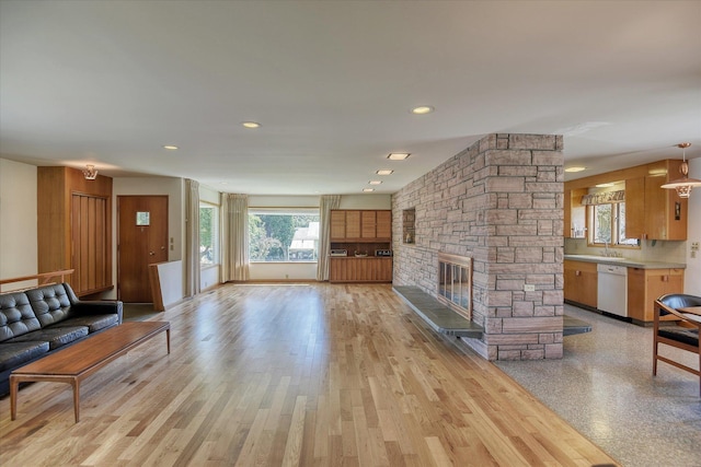 3303 W 8th Ave, Spokane, WA 99224 - unfurnished living room with a stone fireplace, recessed lighting, and light wood finished floors