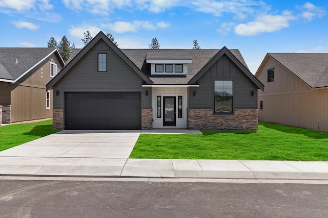 13306 N Starling Ln, Spokane, WA 99208 - view of front of property with concrete driveway, board and batten siding, a garage, a front yard, and a shingled roof