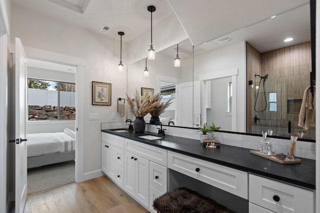 13306 N Starling Ln, Spokane, WA 99208 - ensuite bathroom featuring double vanity, wood finished floors, tiled shower, and recessed lighting