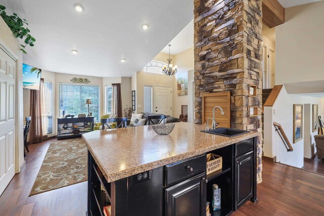 6709 S Moran View St, Spokane, WA 99224 - kitchen with dark cabinets, dark wood-type flooring, open floor plan, light countertops, and a kitchen island with sink