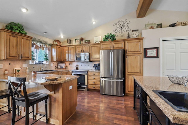 6709 S Moran View St, Spokane, WA 99224 - kitchen featuring stainless steel appliances, decorative backsplash, dark wood-style floors, light stone counters, and a peninsula