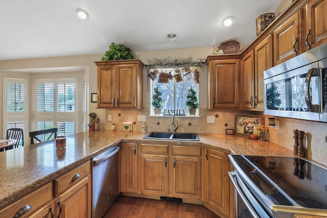 6709 S Moran View St, Spokane, WA 99224 - kitchen featuring stainless steel appliances, brown cabinets, healthy amount of natural light, decorative backsplash, and recessed lighting