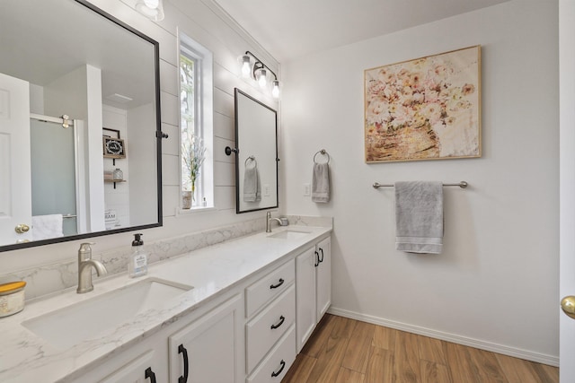 6709 S Moran View St, Spokane, WA 99224 - bathroom featuring double vanity, wood finished floors, and a shower with door