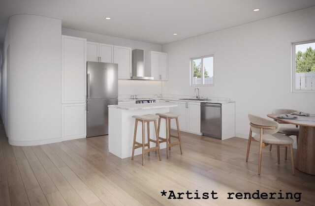 1324 W Dalke Ave Unit B, Spokane, WA 99205 - kitchen with appliances with stainless steel finishes, wall chimney range hood, a kitchen bar, white cabinets, and a center island