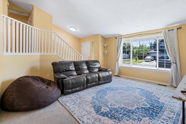 4129 E 32nd Ave, Spokane, WA 99223 - carpeted living room featuring stairway and a textured ceiling